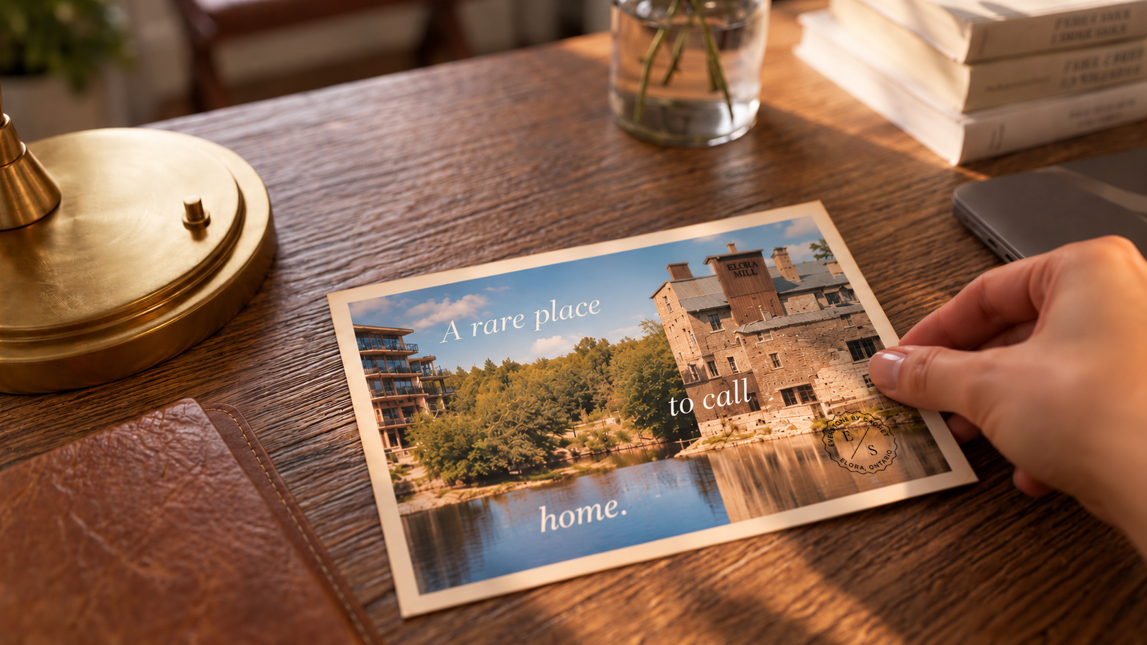 Everstone branded postcard showing Elora Mill on a sunlit desk