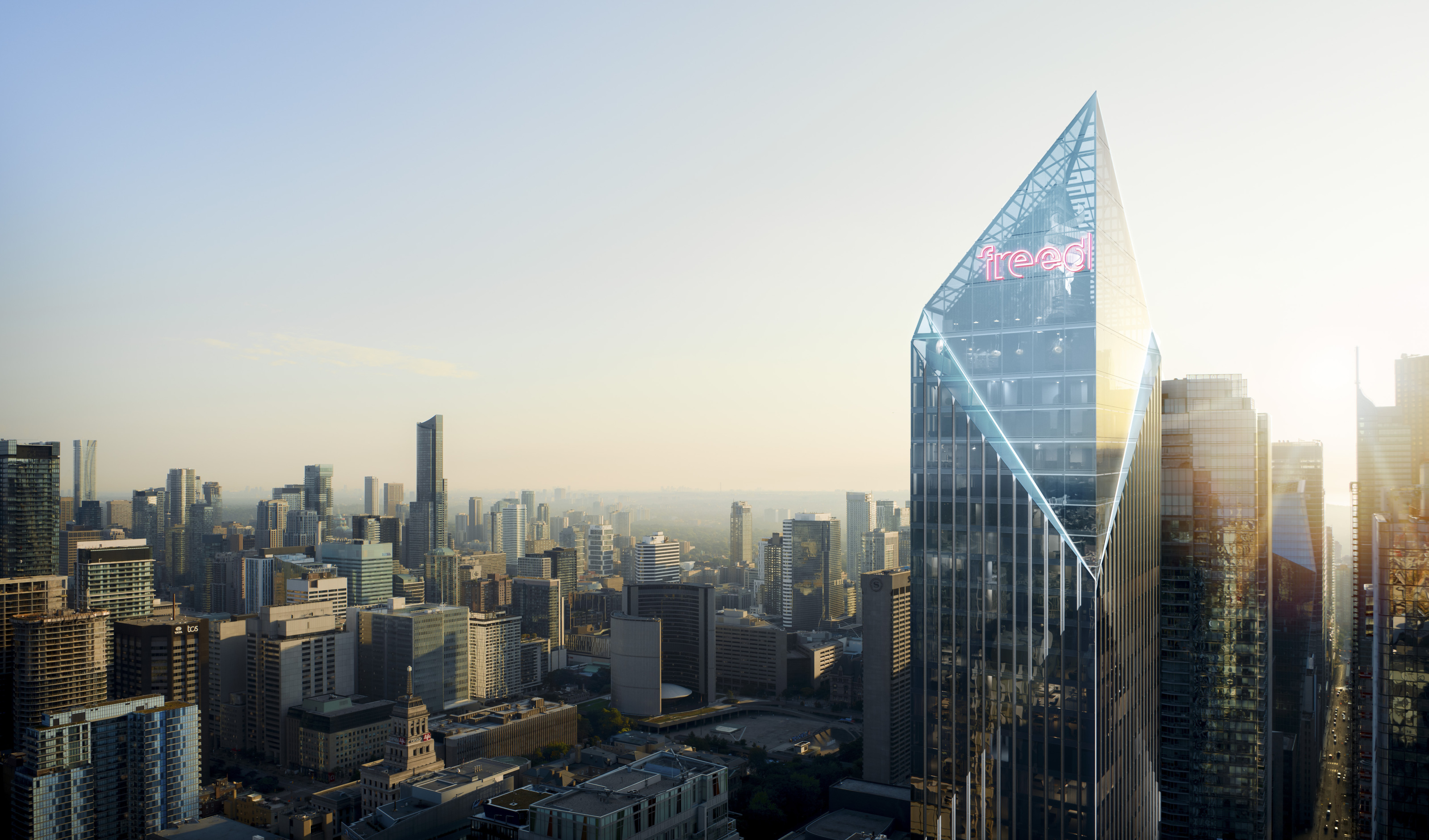Warm-lit Jewelbox crown of Freed Hotel against the city skyline